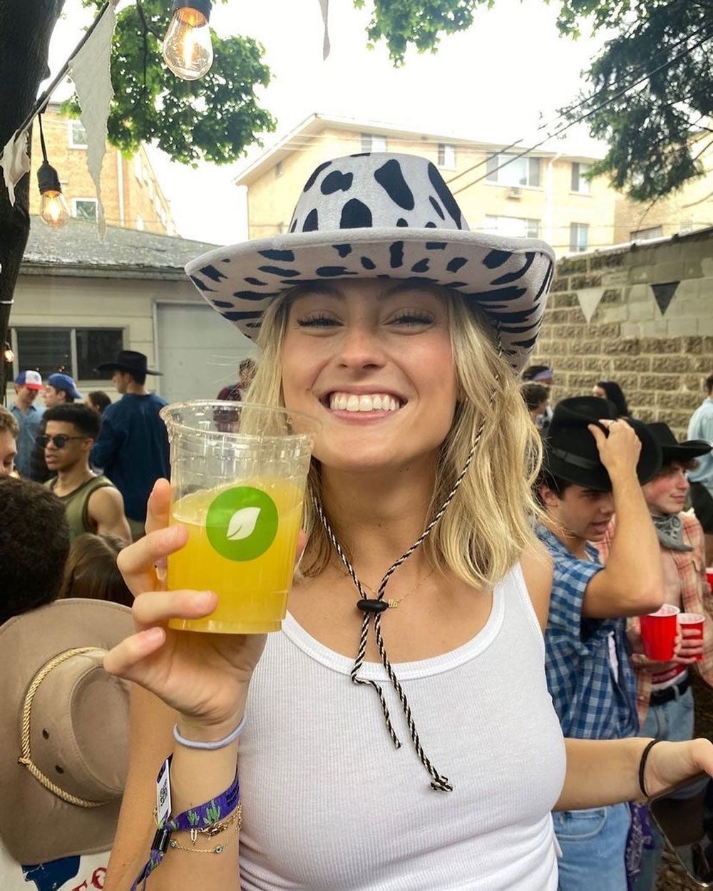 College Girl with Cowgirl Hat Holding Compostable Earth Cup
