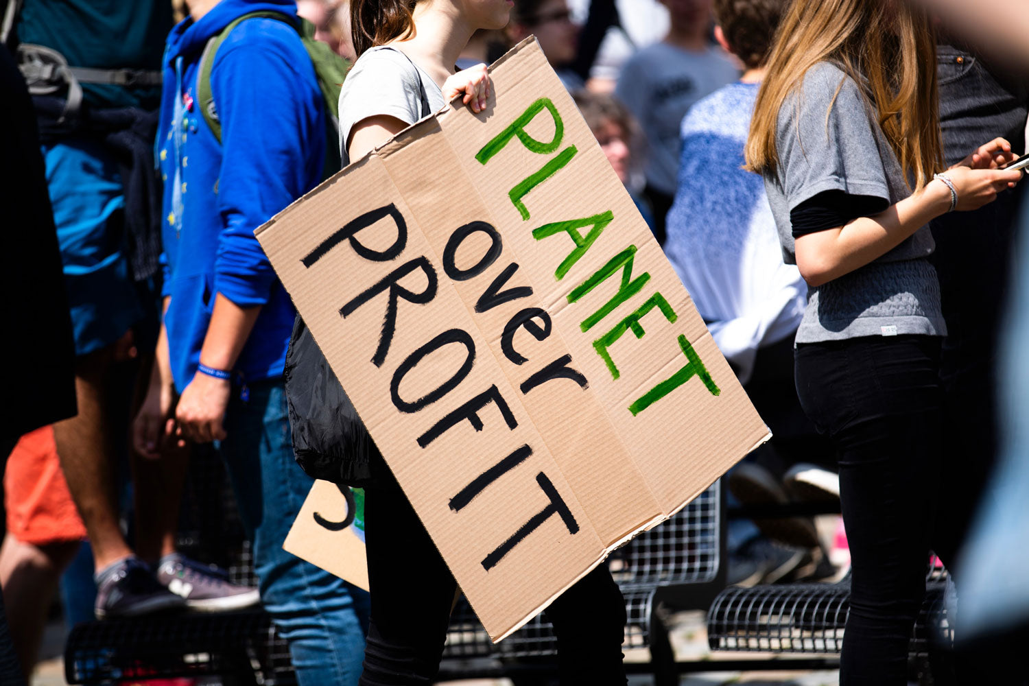 Climate Change Rally with Protester holding sign that reads 'Planet over Profit'